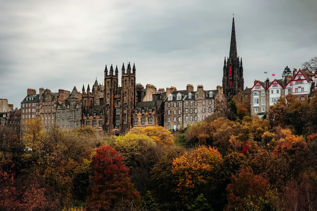 Edinburgh's Old Town skyline above autumn trees in Princes Street Gardens