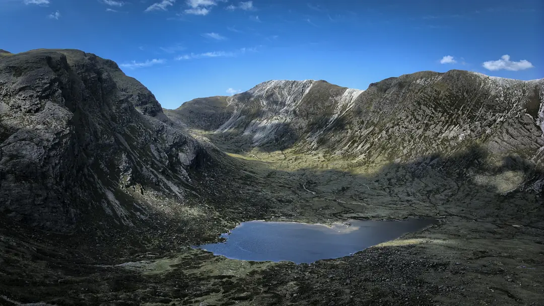 A corrie lochan below the steep sandstone walls of the Torridon hills